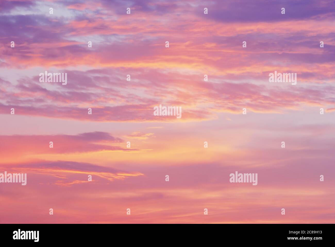 pink purple orange clouds in sunset sky, blurry natural dawn sky background Stock Photo