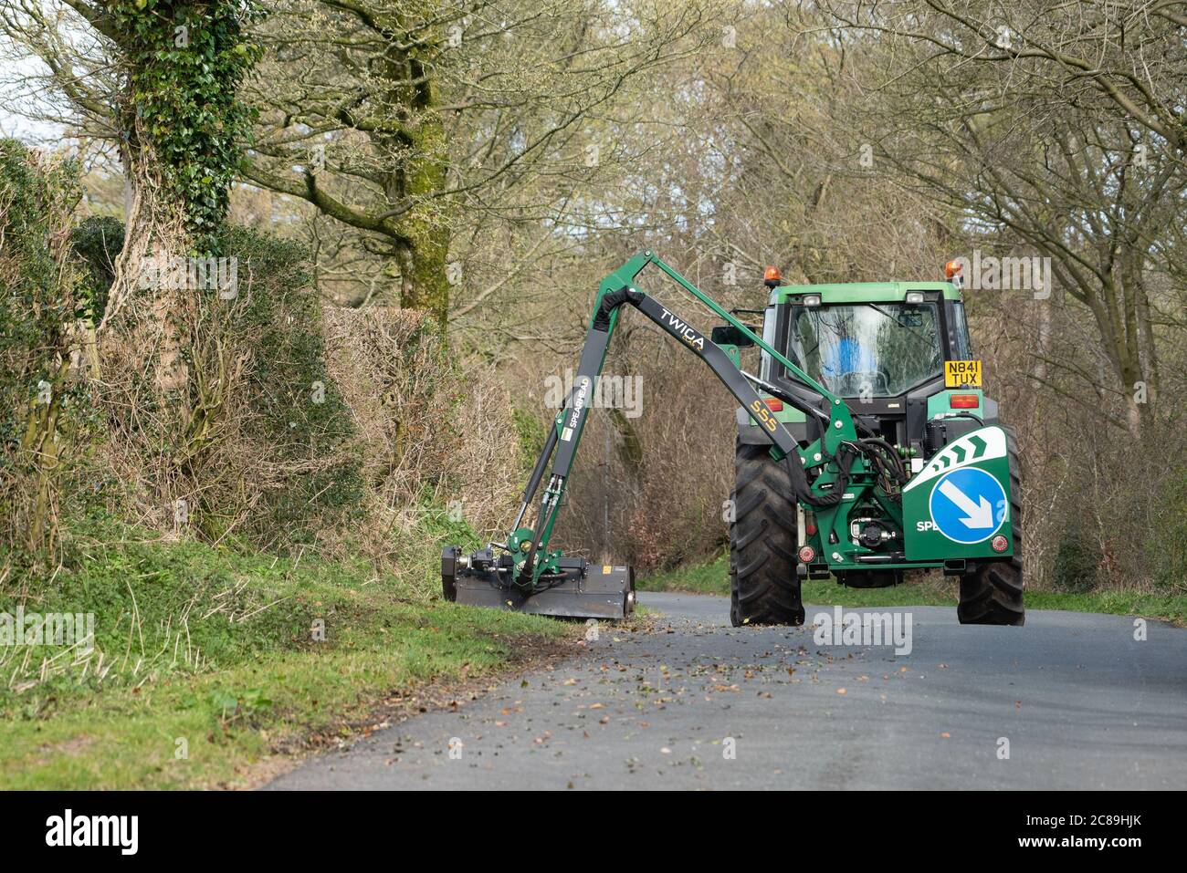 Cutting the grass verges with Spearhead mower and John Deere tractor, Chipping, Preston, Lancashire, England, United Kingdom. Stock Photo