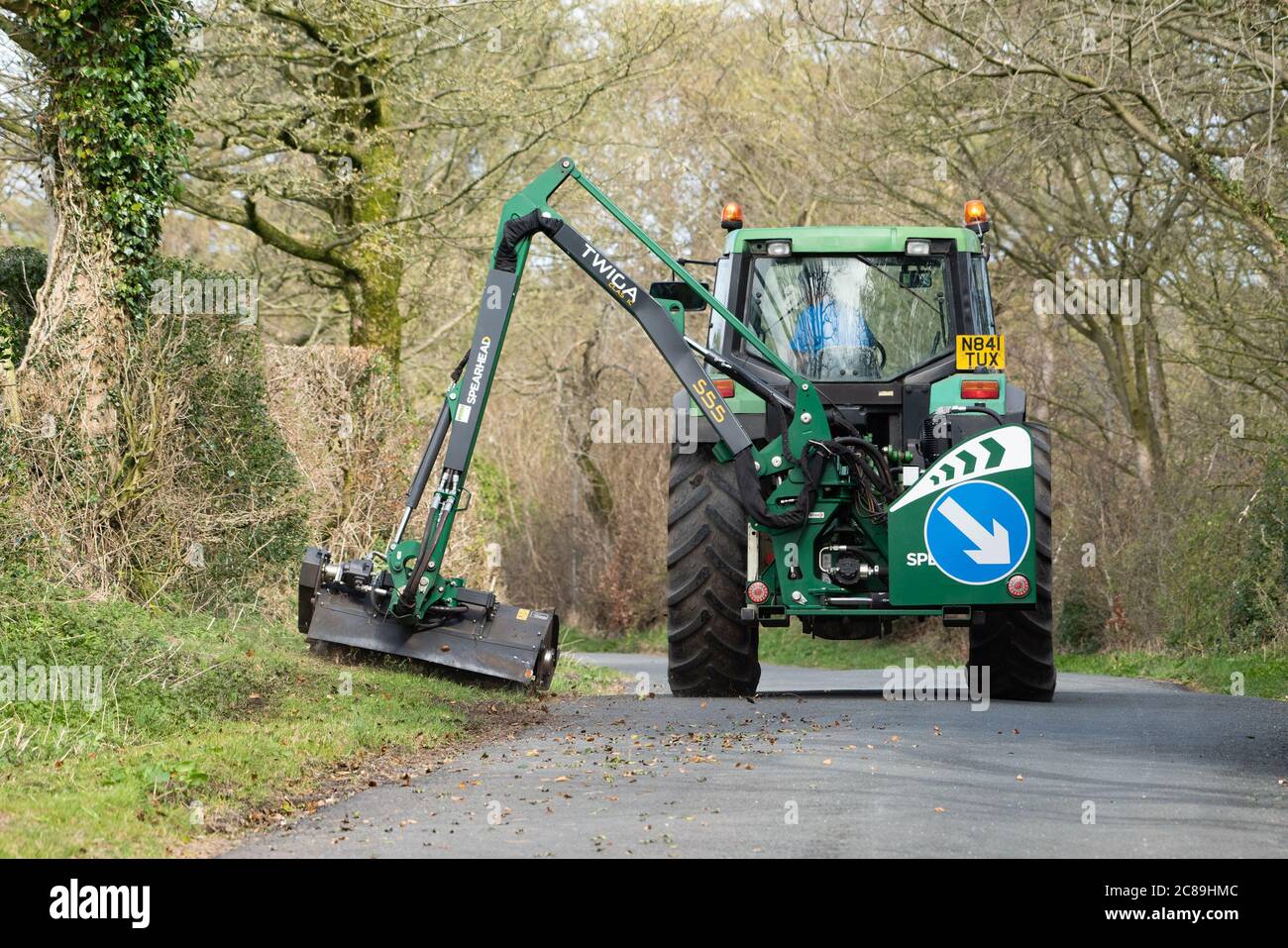 Cutting the grass verges with Spearhead mower and John Deere tractor, Chipping, Preston, Lancashire, England, United Kingdom. Stock Photo