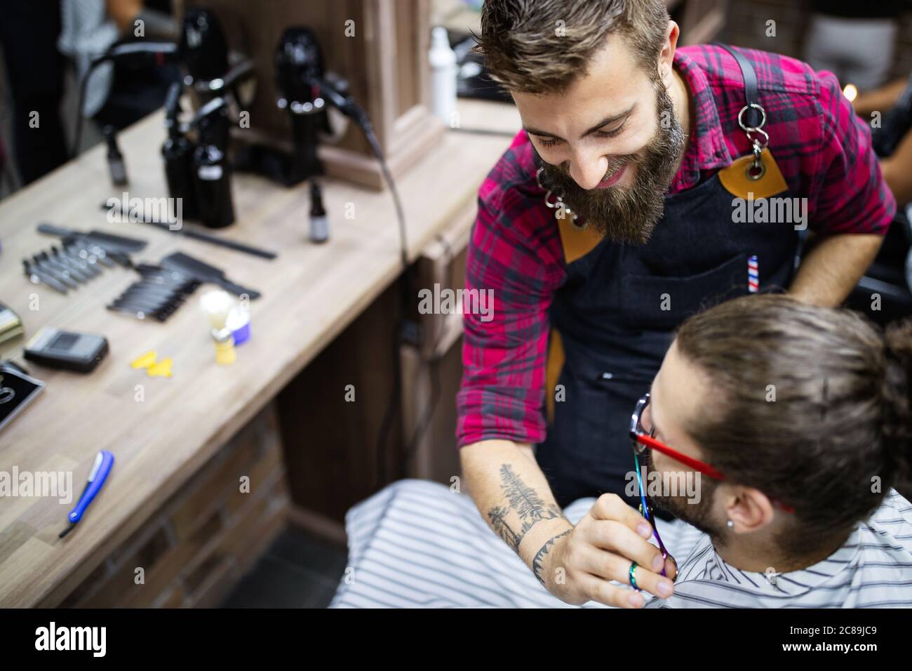 Client during beard and moustache grooming in barber shop Stock Photo ...