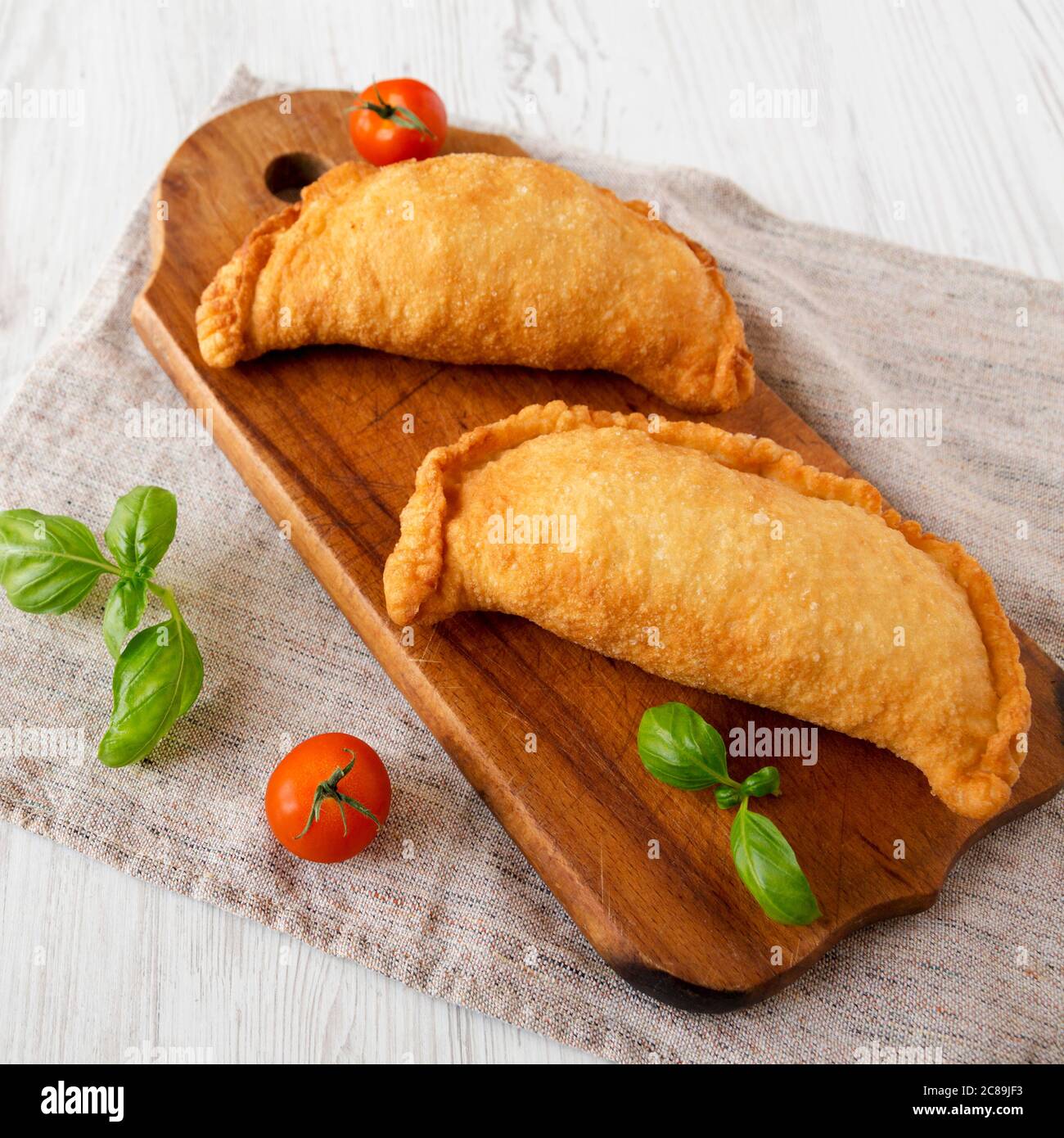 Homemade Deep Fried Italian Panzerotti Calzone on a rustic wooden board