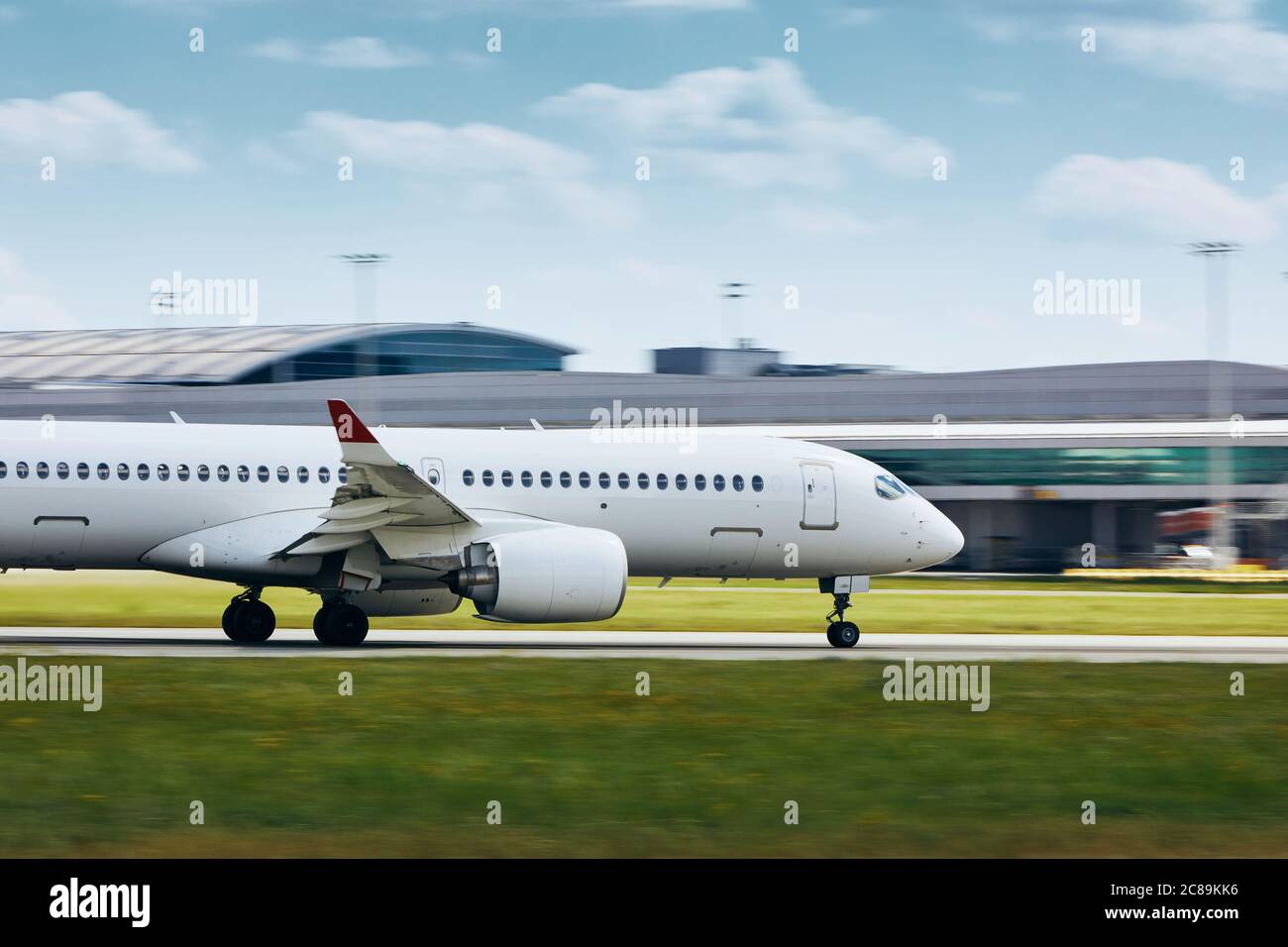 Passenger airplane accelerates on airport runway for take off. Stock Photo