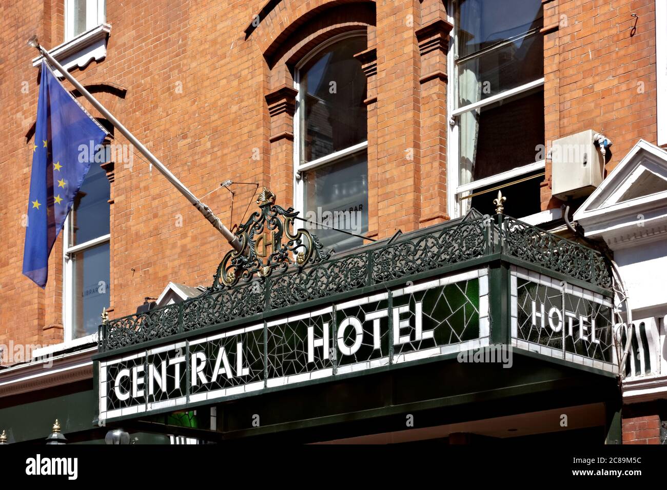 Retro stained glass sign at the Central Hotel, exterior. Red bricks building facade. Travel destinations. Dublin City, Ireland, Europe. EU. Close up. Stock Photo