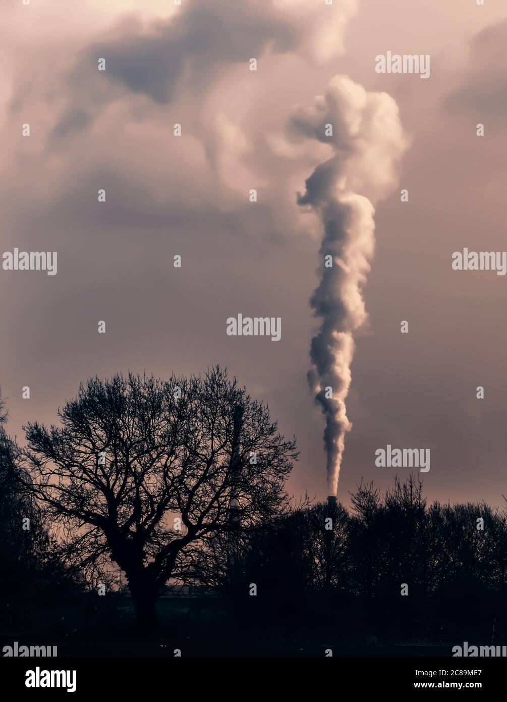 Smoke emission from chimney. Cause of global warming. Conception of air pollution and smog issue. Factory steam contaminate atmosphere. Fumes from bur Stock Photo