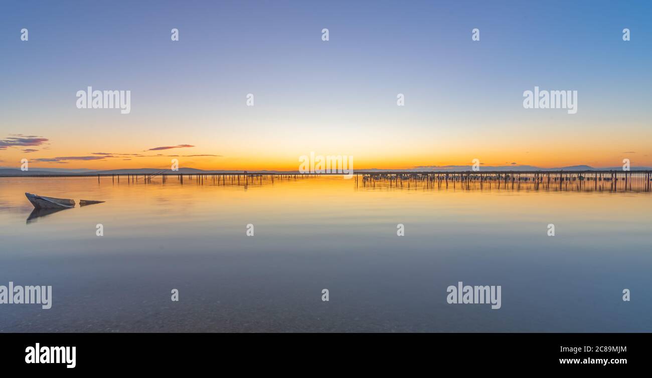 Sunset on a pond with mussel breeding grounds. Stock Photo