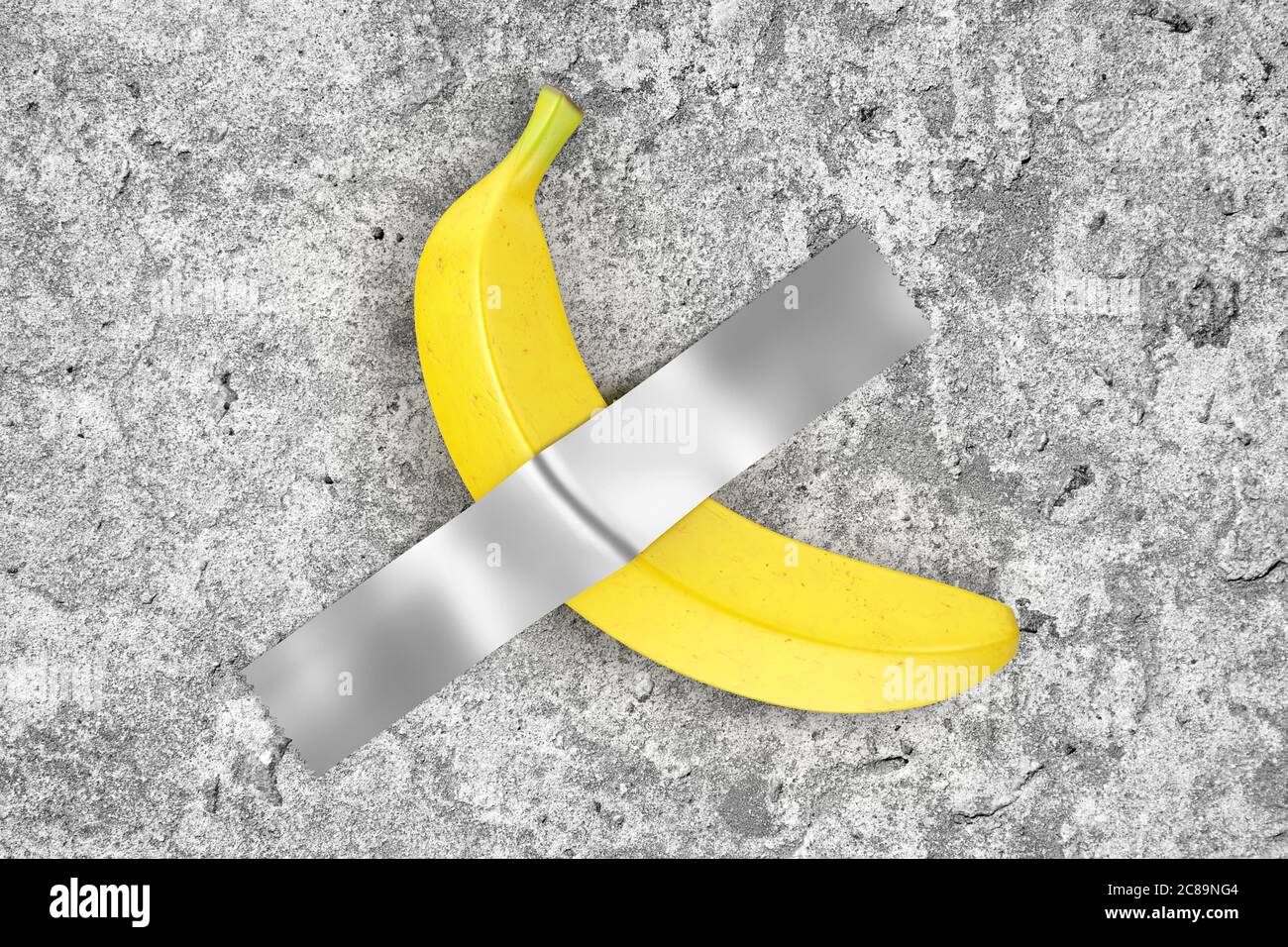 Single Ripe Yellow Banana Duct Taped to Concrete Wall extreme closeup