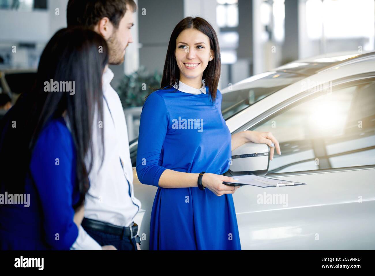 Saleswoman offering to take drive test on chosen car at sunsine car