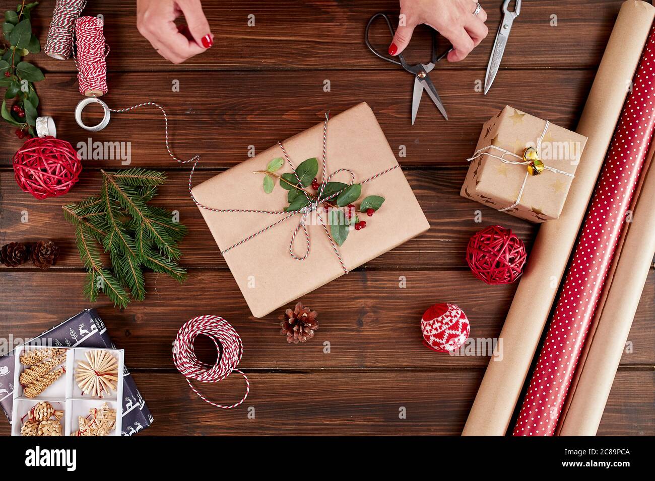 Christmas still life with eco friendly kraft wrapping paper and gift packaging, natural. Eco Christmas packages with brown paper, string and natural g Stock Photo