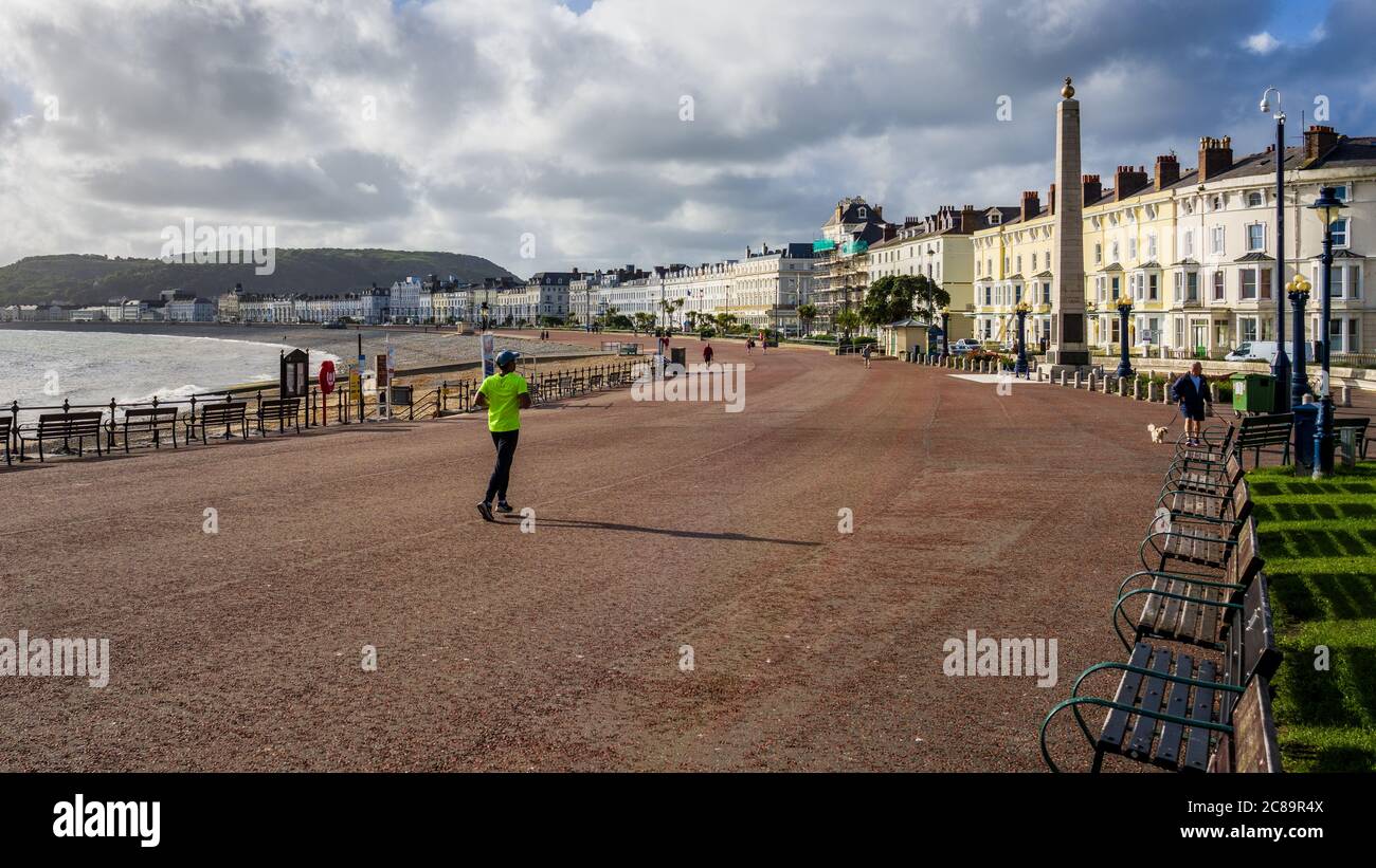 Llandudno Seafront Runner - early morning jogger on the Seafront in Llandudno North Wales during lockdown Stock Photo