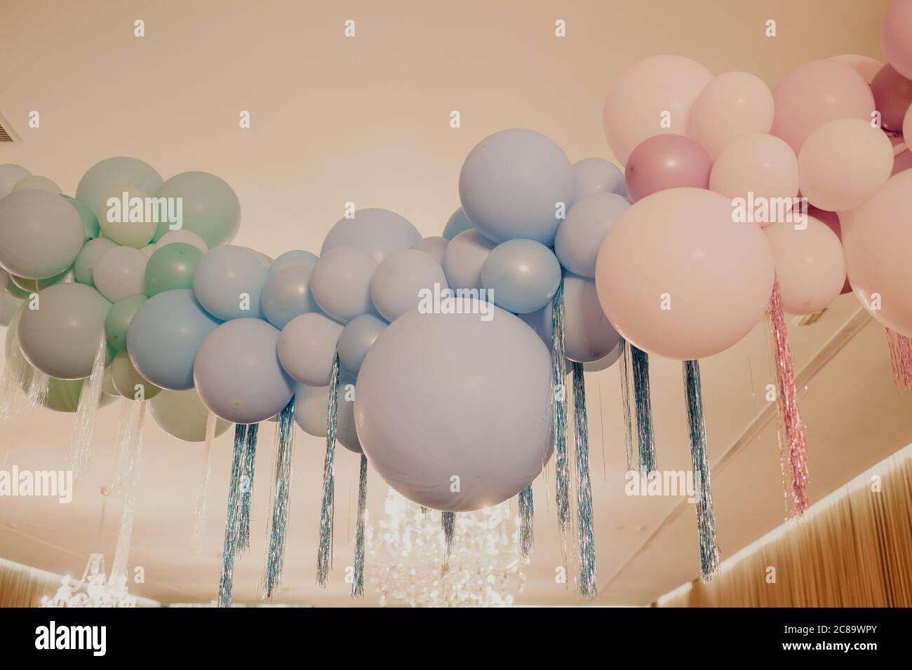 Low angle shot of colorful balloons decoration hanging from the ceiling  Stock Photo - Alamy