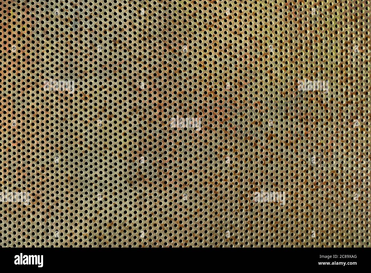 Old, rusted and weathered perforated plate Stock Photo