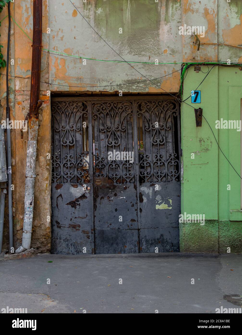 Old decaying building with rusty wrought iron gates Stock Photo Alamy