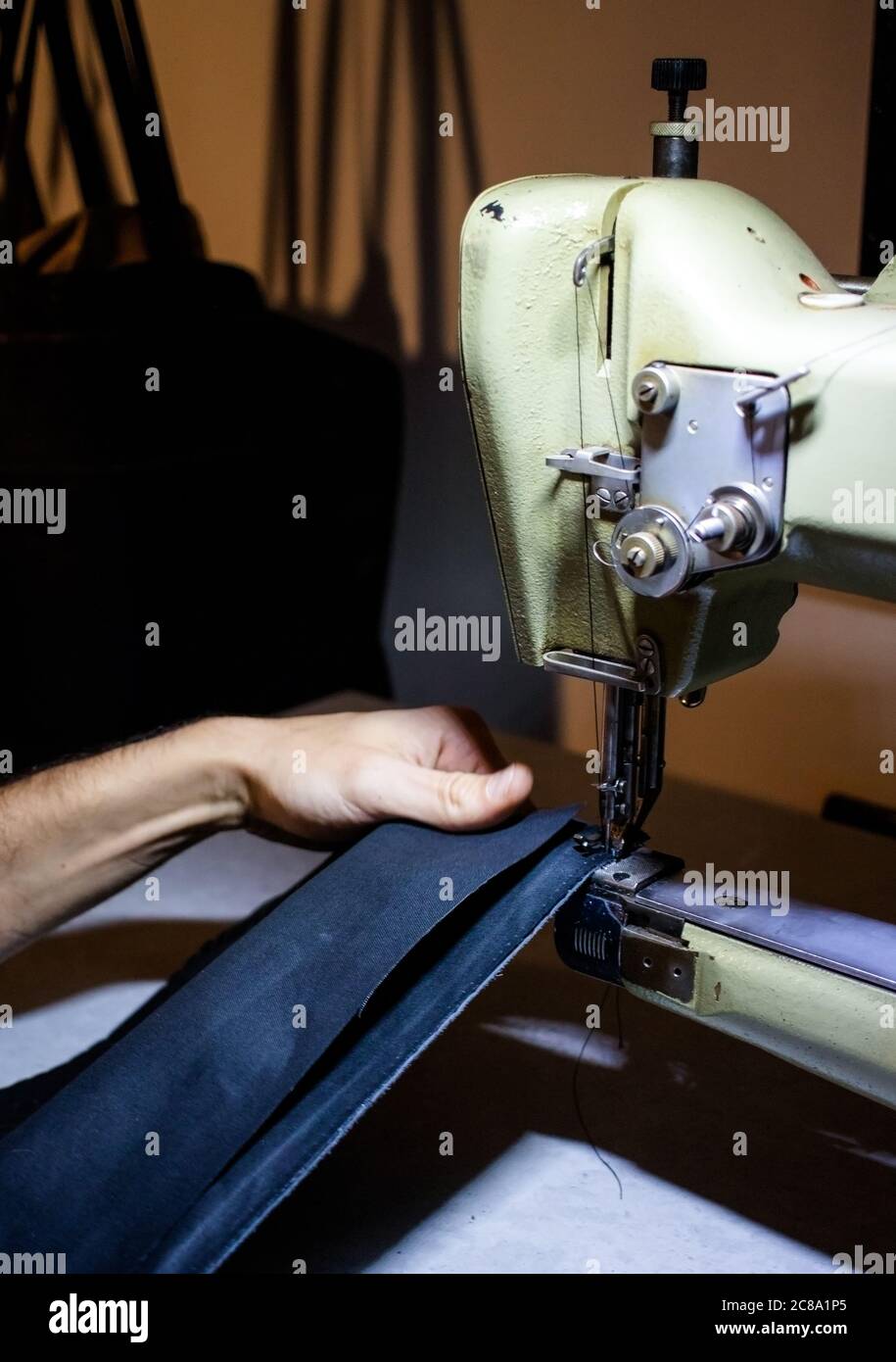 craftsman working with leather and sewing machine Stock Photo