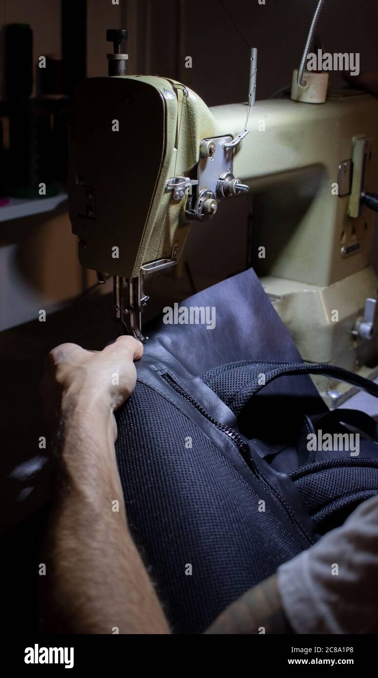 craftsman working with leather and sewing machine Stock Photo