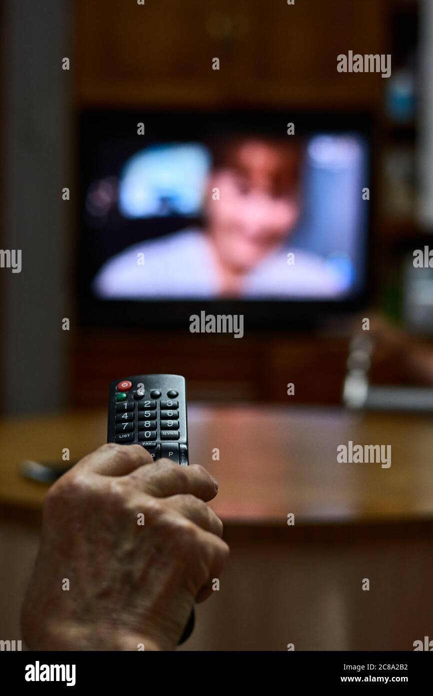 Close-up of an old man changing channels Stock Photo