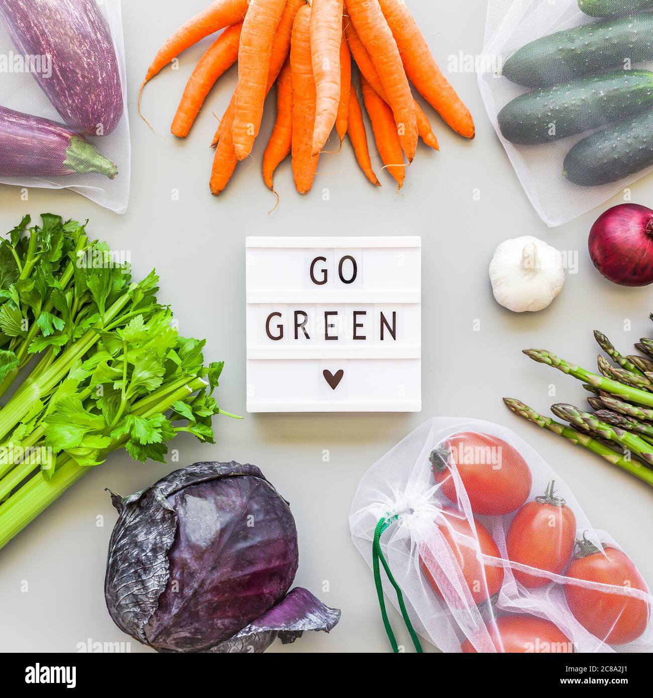 Human betale Addiction Fresh organic vegetables in eco reusable produce shopping bags flat lay, top  view and lightbox with text Go Green, gray background. Sustainable lifest  Stock Photo - Alamy