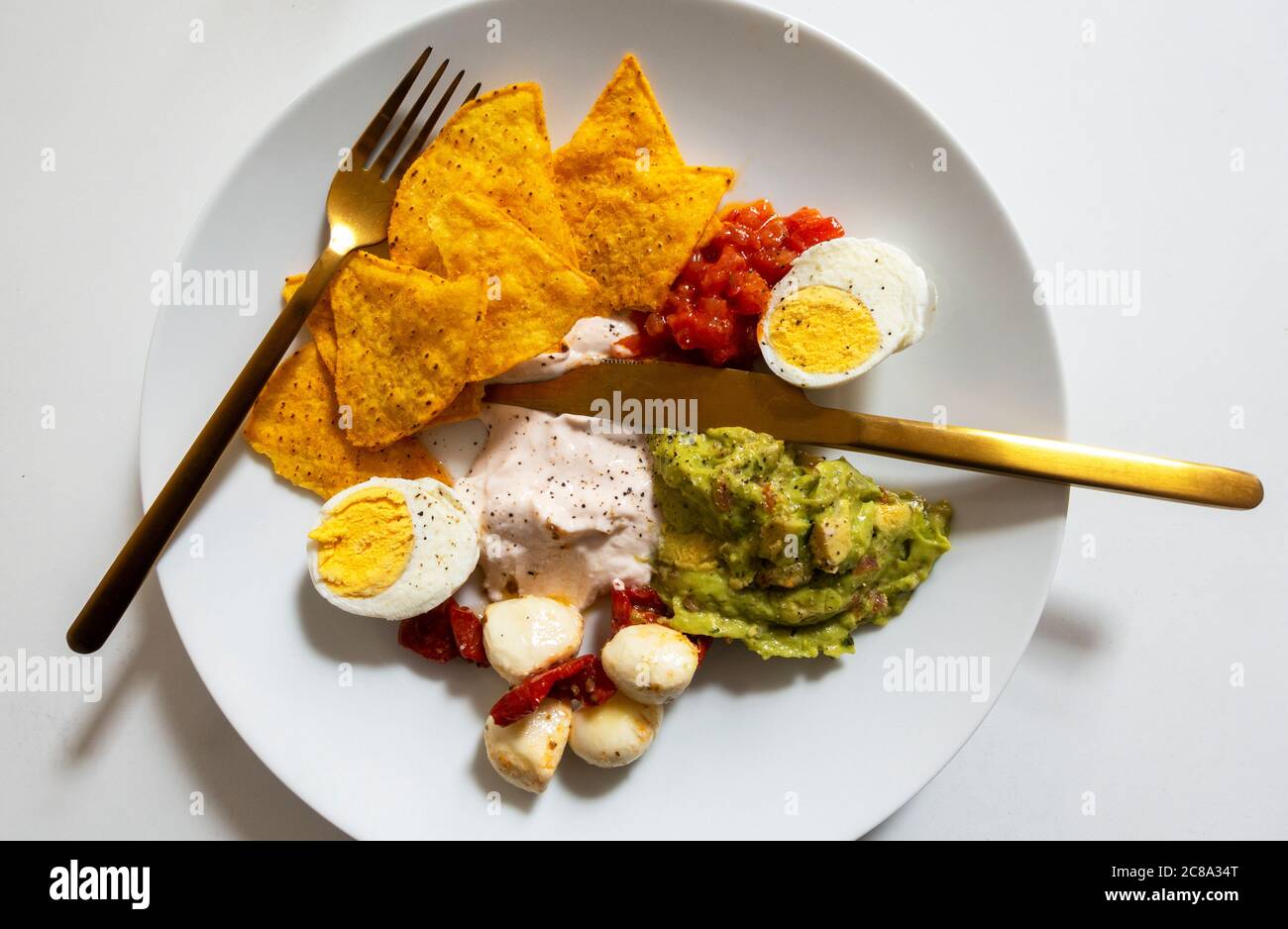 A mix of antipasti on a white plate Stock Photo