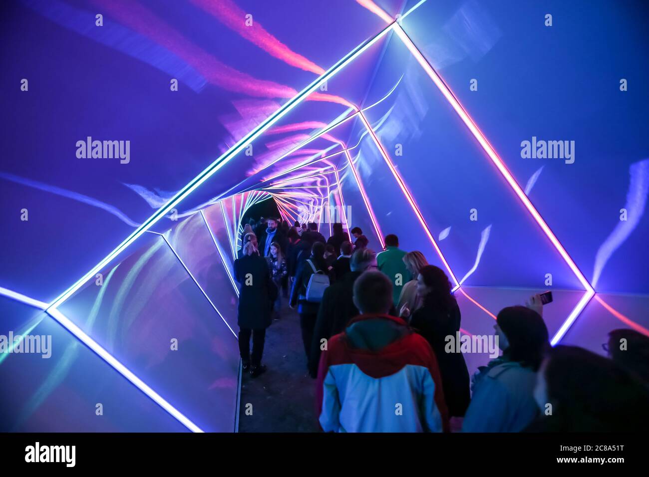 Zagreb, Croatia - 19 March, 2017 : Festival of lights in Zagreb, Croatia. People walking through a lighted tunnel installation with colorful neon ligh Stock Photo