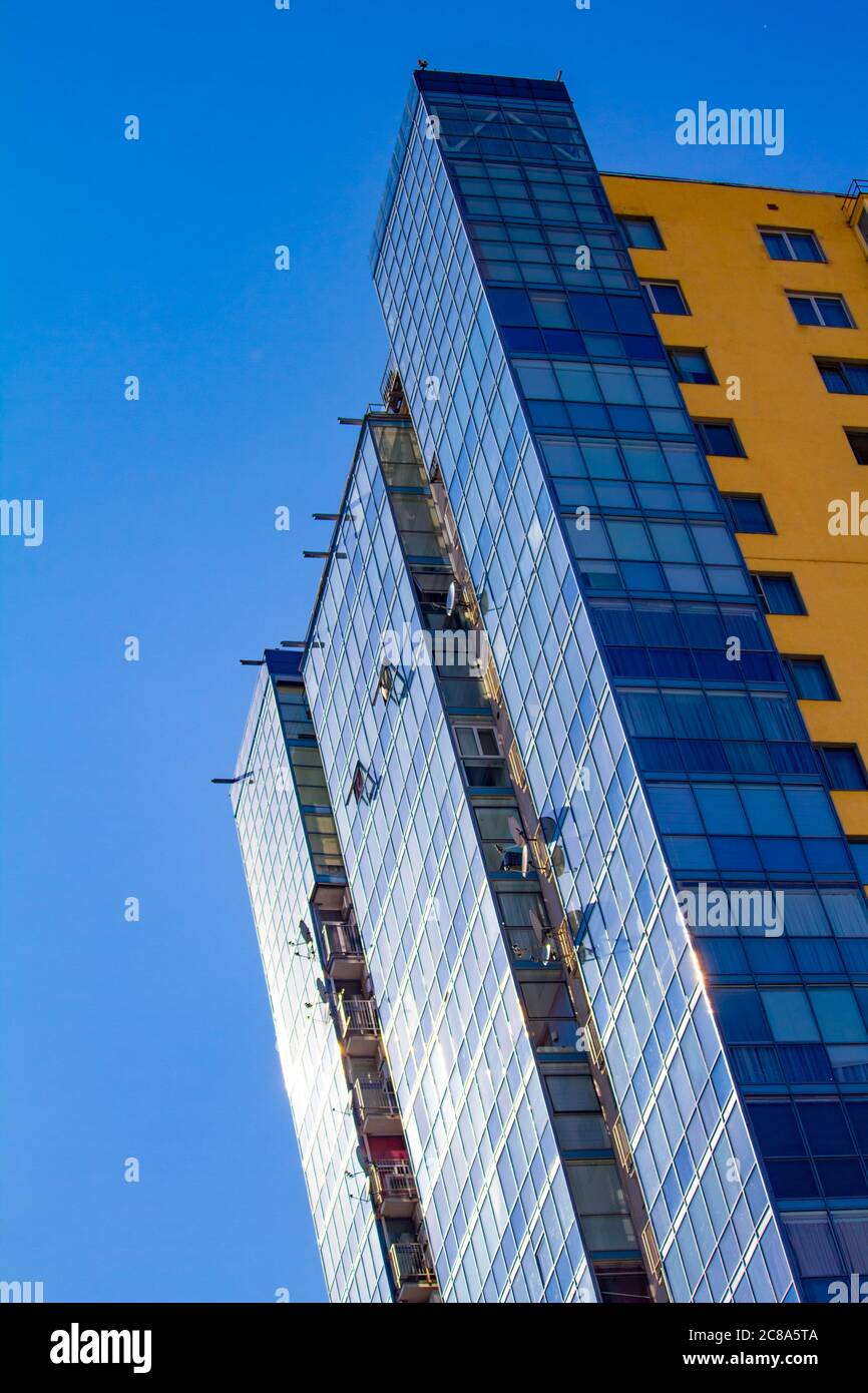 New block of modern apartments with balconies and blue sky background, free space for text Stock Photo