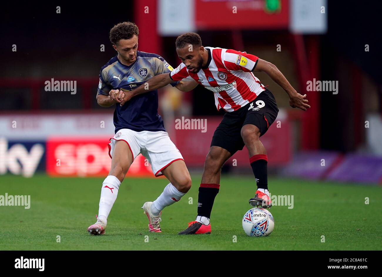 Brentford's Bryan Mbeumo (right) and Barnsley's Jordan Williams battle for the ball during the Sky Bet Championship match at Griffin Park, London. Stock Photo