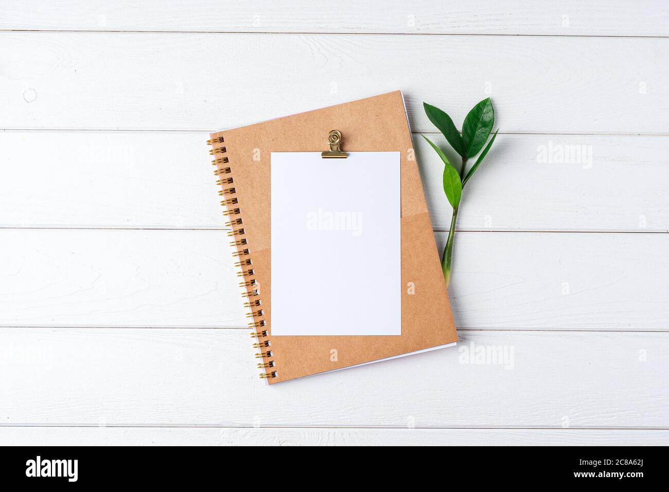 Empty notepad and modern smart phone mockup on white office desk surrounded  with office supplies. Top view. Flat lay Stock Photo - Alamy