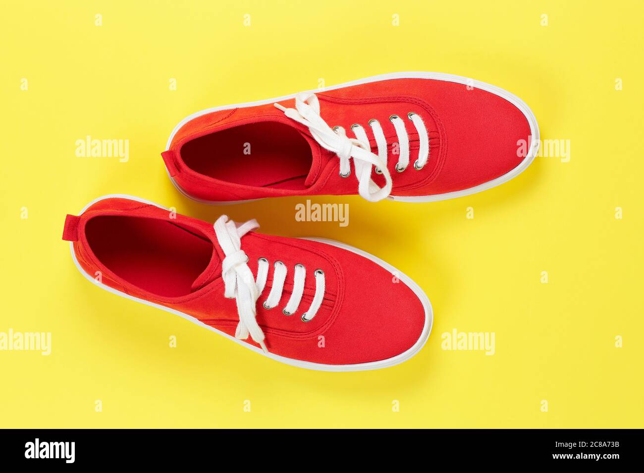 pair of red suede shoes on yellow surface Stock Photo - Alamy