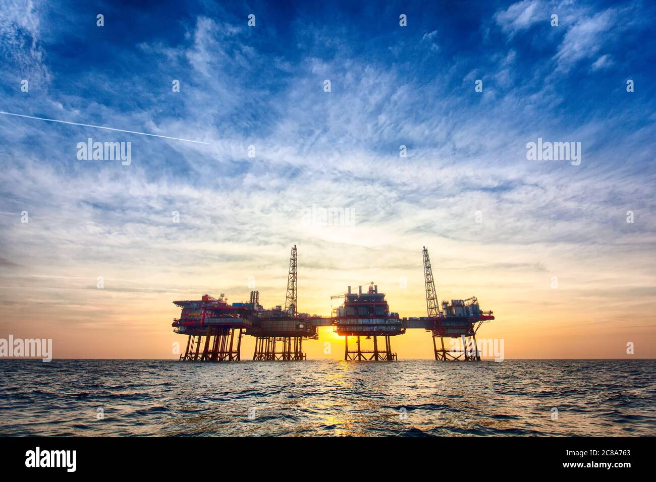 Offshore oil platform at sunset time Stock Photo