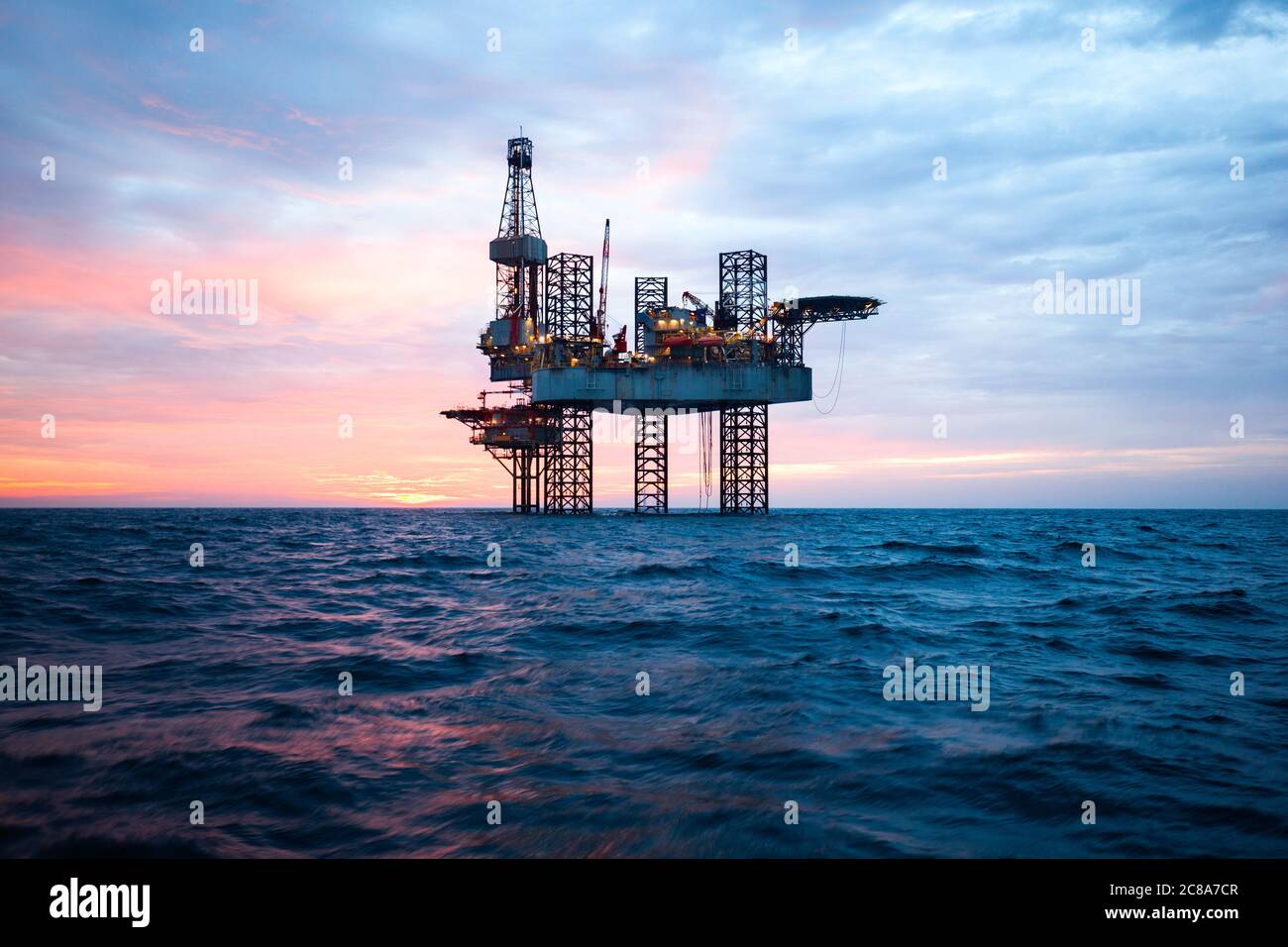 Oil rig at sunset time Stock Photo