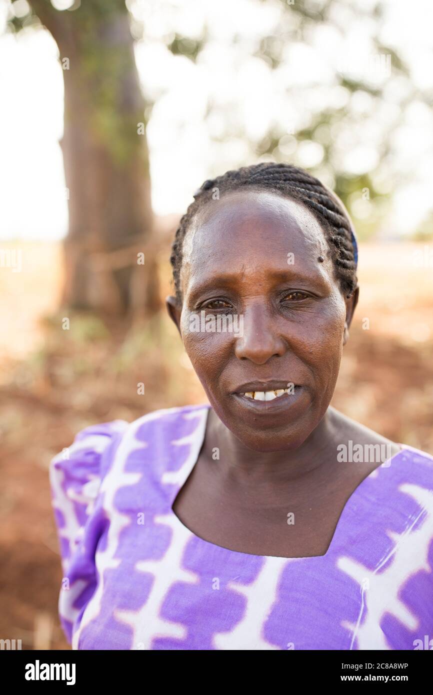 Portrait of a woman with a somber expression in an arid landscape in  Makueni County, Kenya, East Africa. Stock Photo