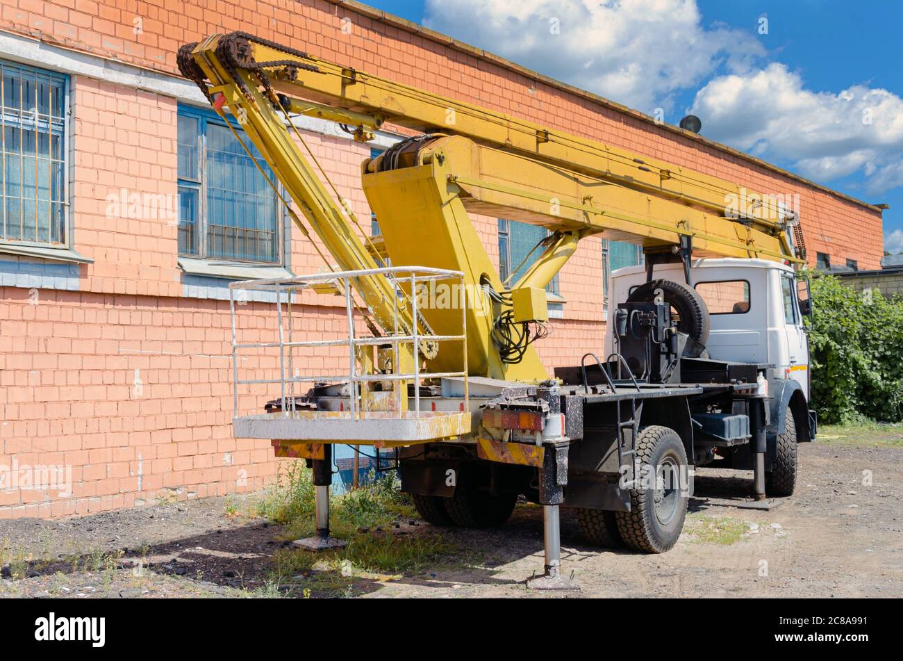 Mobile Crane on a road and tower crane in construction site Stock Photo