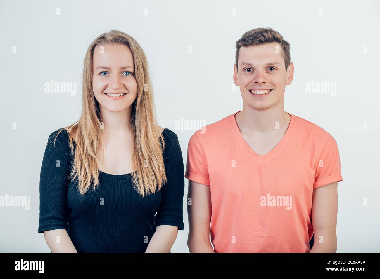Portrait of young couple smiling on white background Stock Photo - Alamy
