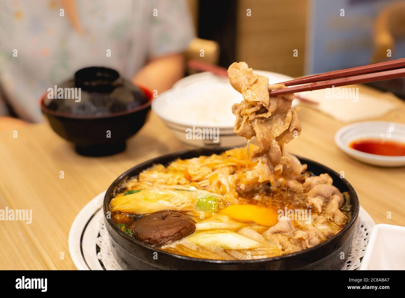 https://c8.alamy.com/comp/2C8ABA7/two-people-are-eating-pork-shabu-or-hot-pot-family-time-2C8ABA7.jpg