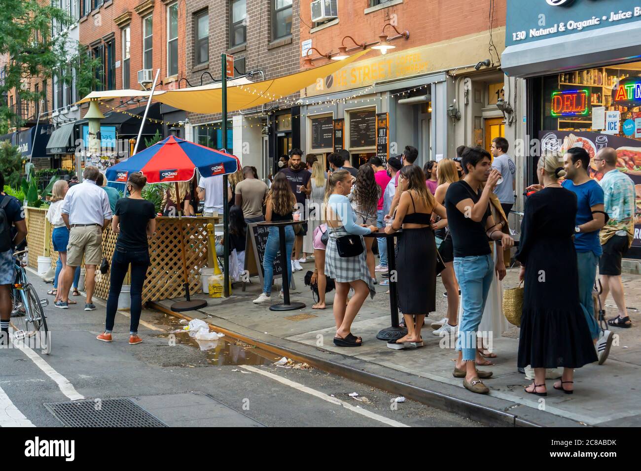Crowds of people congregate outside of Bathtub Gin in the Chelsea neighborhood of New York as the bar celebrates its 9th anniversary with a party on Thursday, July 16, 2020. NYS Gov. Andrew Cuomo will announce plans for the city to enter Phase 4 of its reopening but no additional indoor activities will be permitted, partially citing issues with bars and restaurants non-compliance. (© Richard B. Levine) Stock Photo
