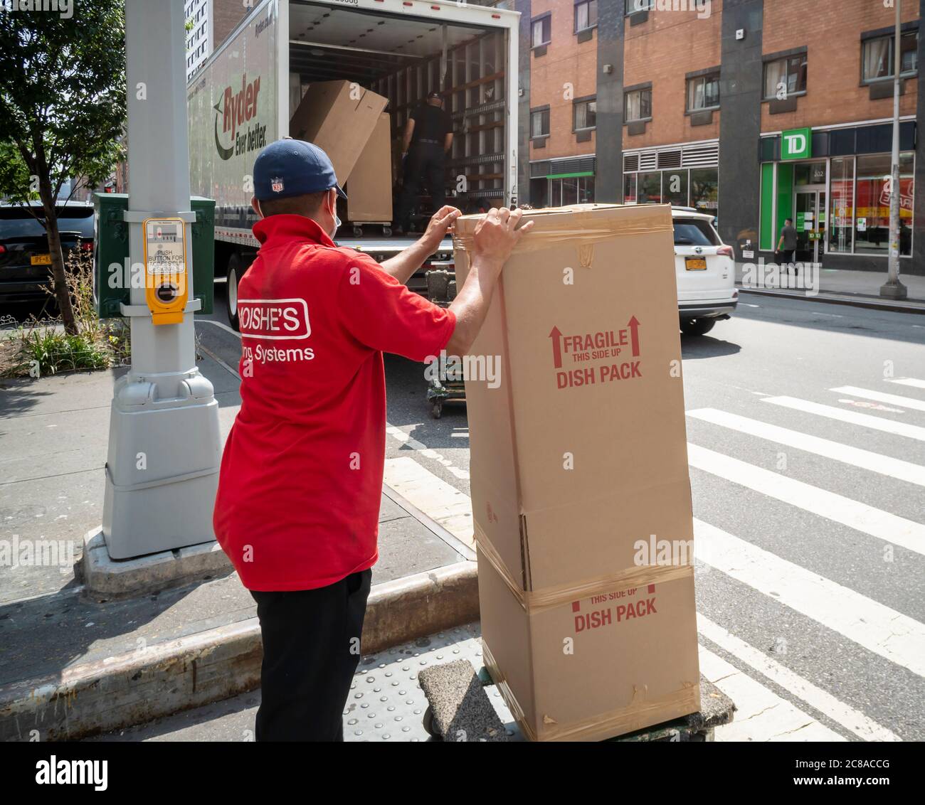 Moving van loading up in the Chelsea neighborhood in New York on Friday, July 17, 2020. (© Richard B. Levine) Stock Photo