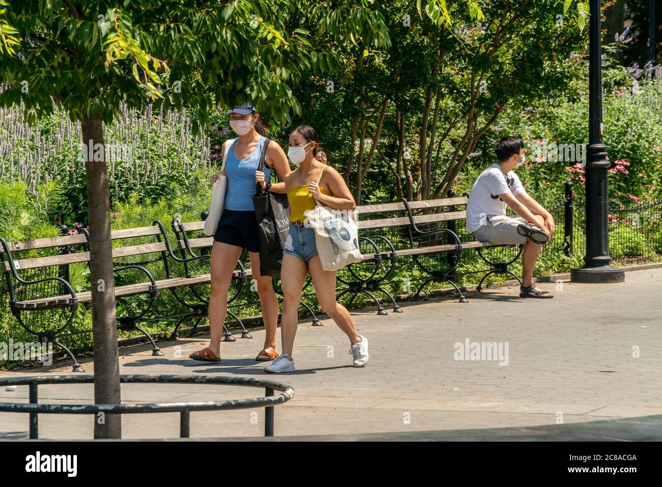 New Yorkers and visitors in Washington Square Park in Greenwich Village in New York on Sunday, July 19, 2020. The city is suffering through min-90s temperatures with Monday’s expected “real-feel” temperature passing 100 degrees. . (© Richard B. Levine) Stock Photo