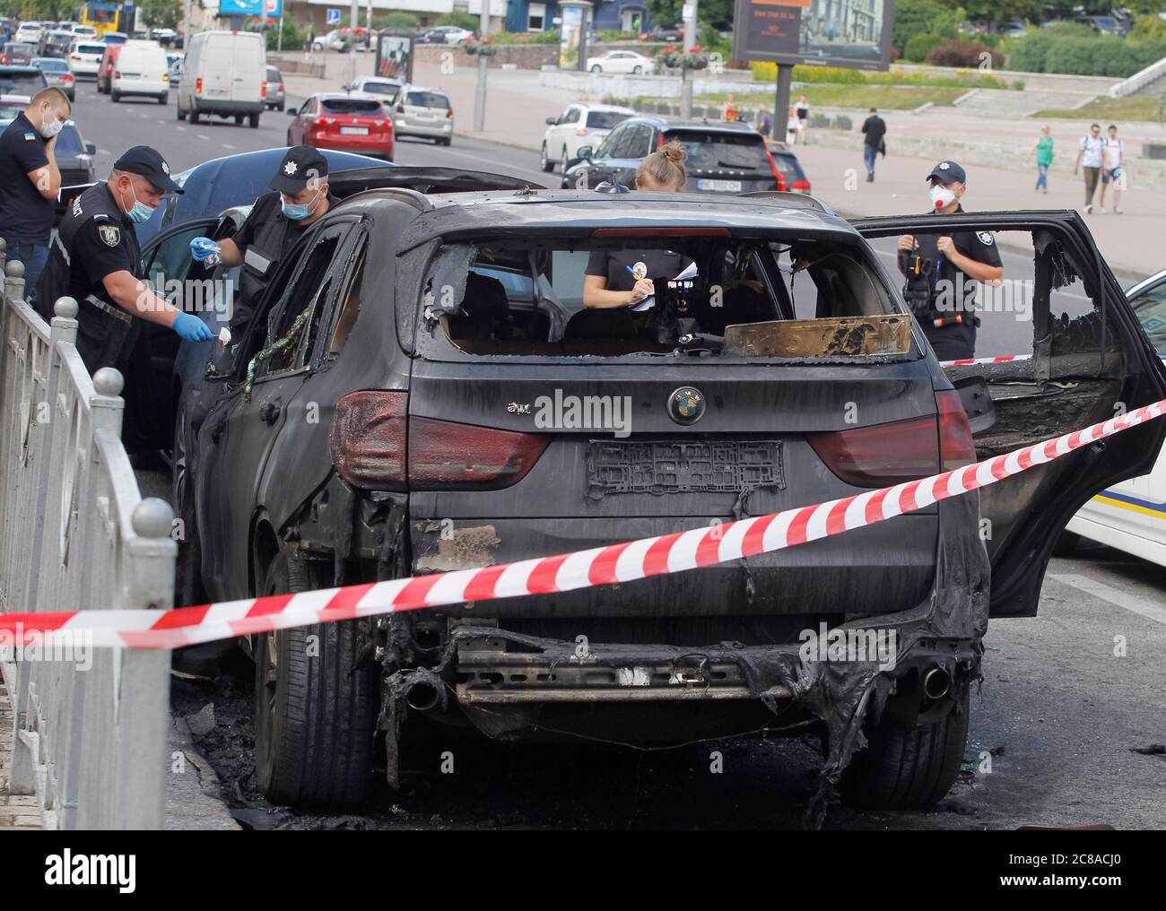 Ukrainian police experts investigate the scene of burned BMW X5 car, after the fire in downtown Kiev. The fire engulfed two cars BMW X5 and Acura, which were parked on the roadside, the State Service of Ukraine for Emergencies facebook page informed. As a result of the fire, the BMW X5 was completely destroyed and the Acura partially destroyed. The cause of the fire is currently being established by police. There are no victims. Stock Photo