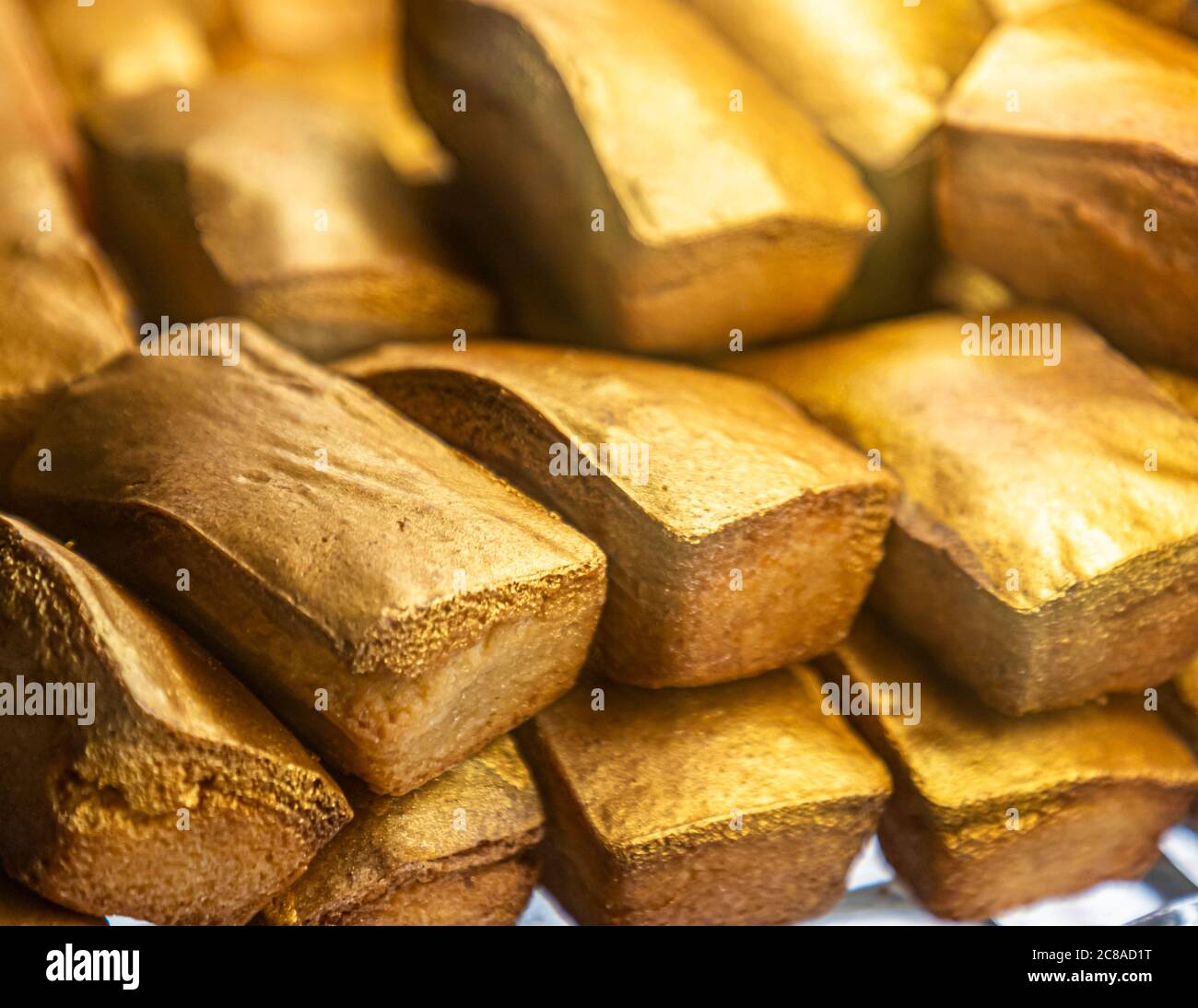 Basler Gold - Typical Golden Cakes from Basel, Switzerland. A golden start to a food tour: the gold piece made from ground almonds and powdered sugar is something like the signature pastry of the KULT bakery in Basel Stock Photo