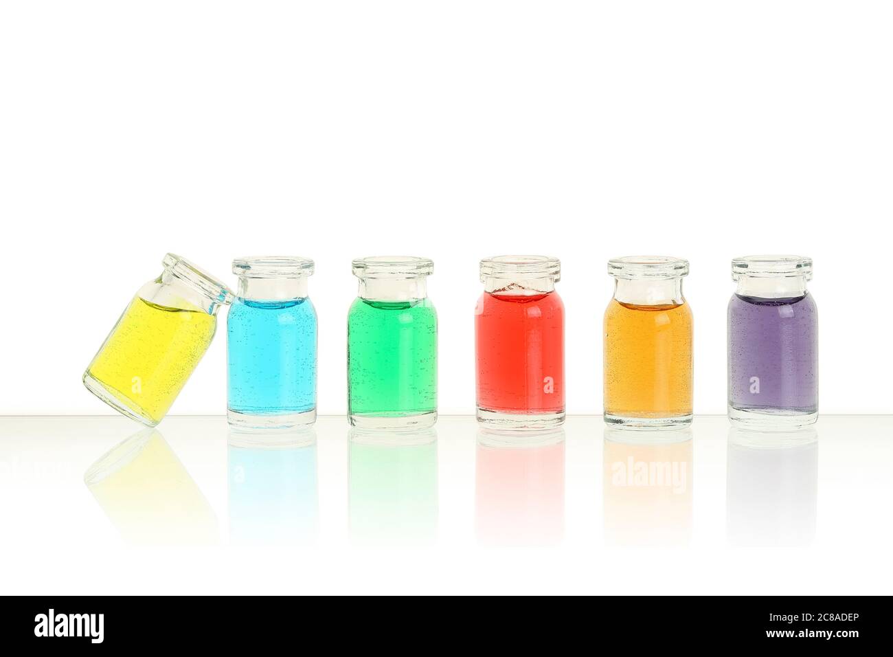 six bottles with different colors on white Stock Photo - Alamy