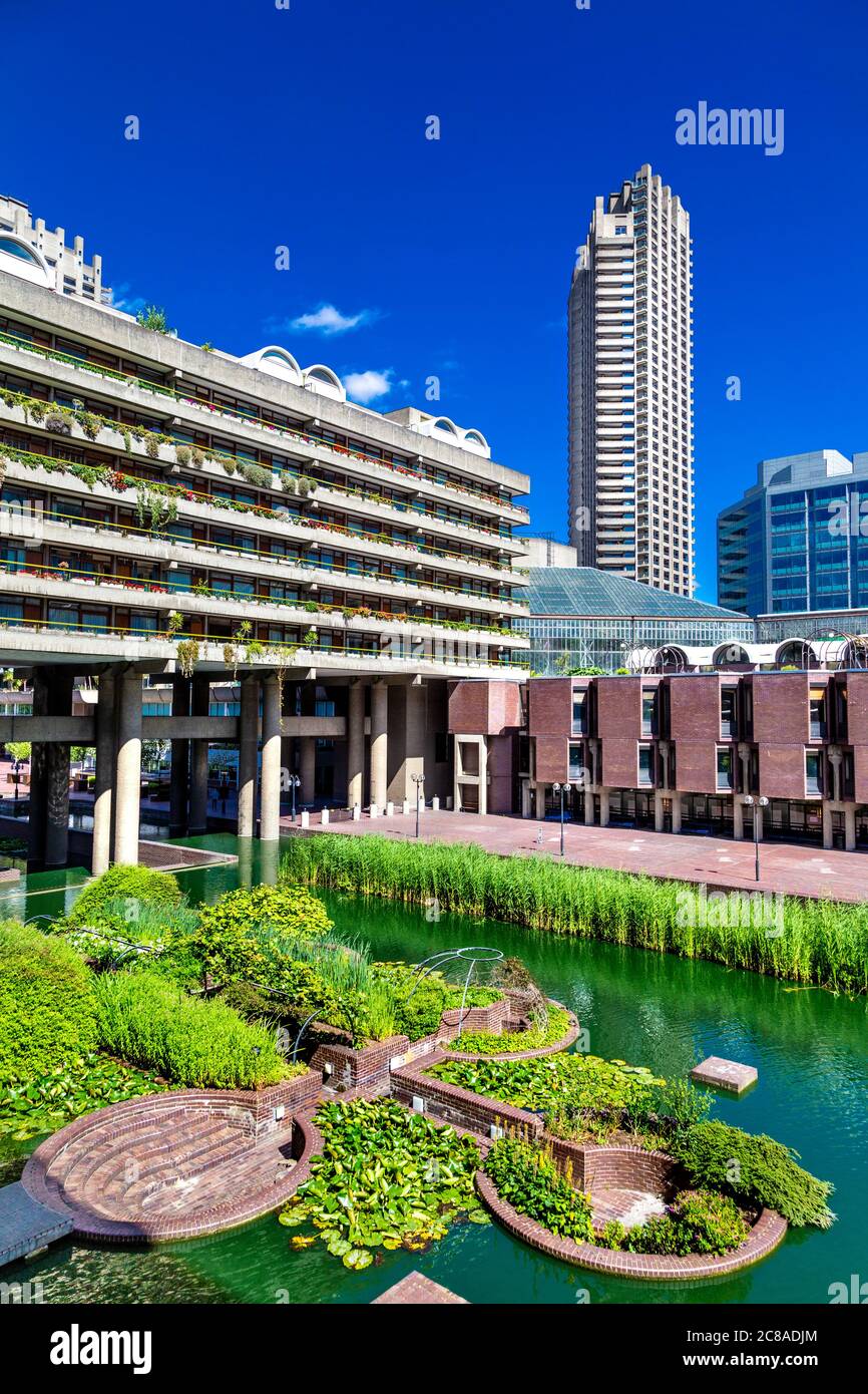 View of water gardens, lakeside terrace, Gilbert House and Cromwell Tower at the brutalist Barbican Estate, London, UK Stock Photo