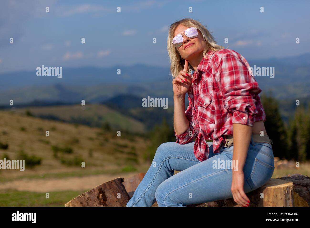 Pretty girl sits on grass hi-res stock photography and images - Alamy