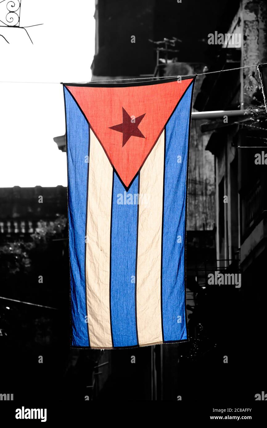 Colorful cuban flag  with a black and white aged Old Havana building on the background Stock Photo