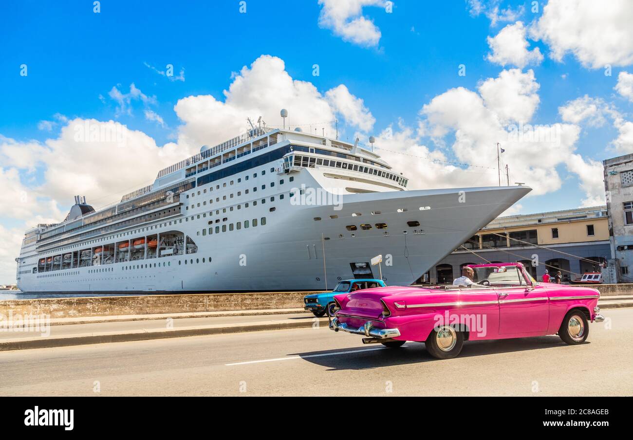 Big cruise ship docked in port of Havana and road with retro old car, Cuba Stock Photo