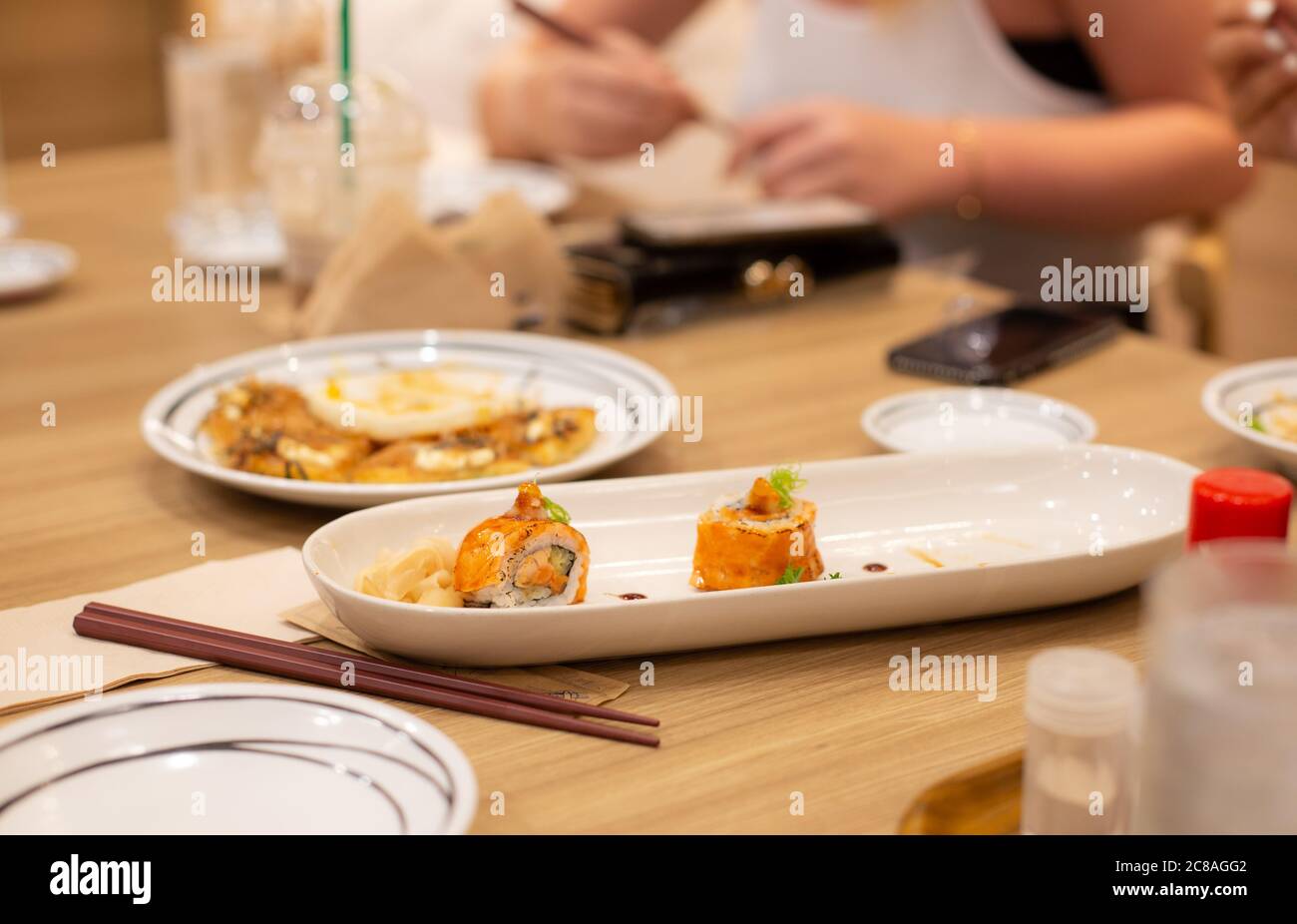 Sushi salmon roll with crispy tempura shrimp, japanese traditional dish. family dinner concept. Stock Photo