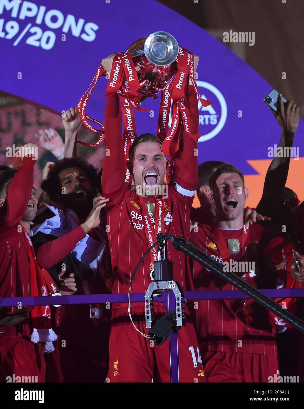 Liverpool's Jordan Henderson celebrates with the Premier League trophy after the Premier League match at Anfield, Liverpool. Stock Photo