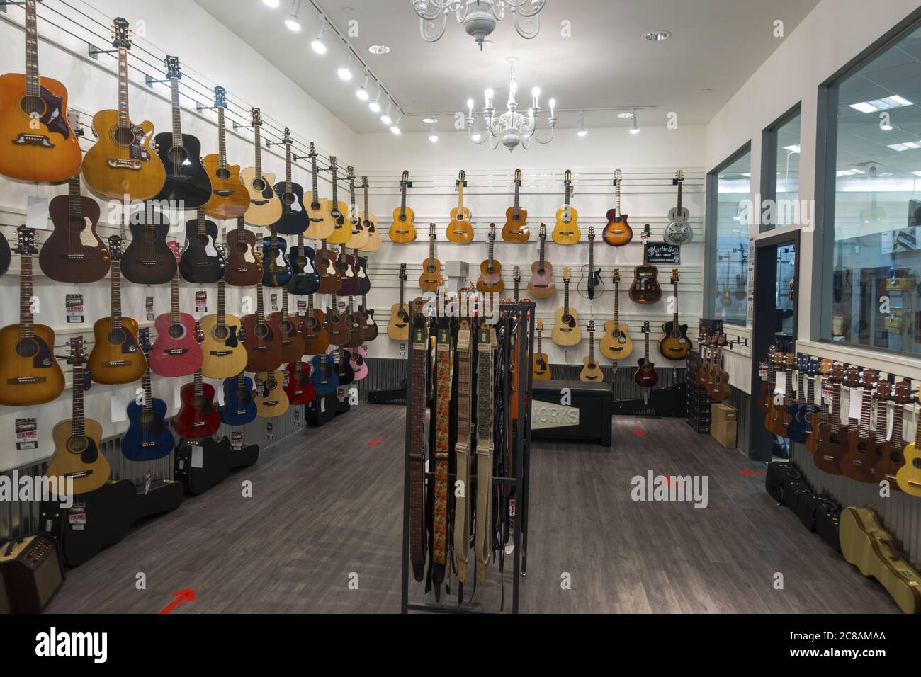 Acoustic and Electrical Music Instruments on Display in Guitar Shop Interior. Calgary, Alberta Market Mall Shopping Centre Stock Photo