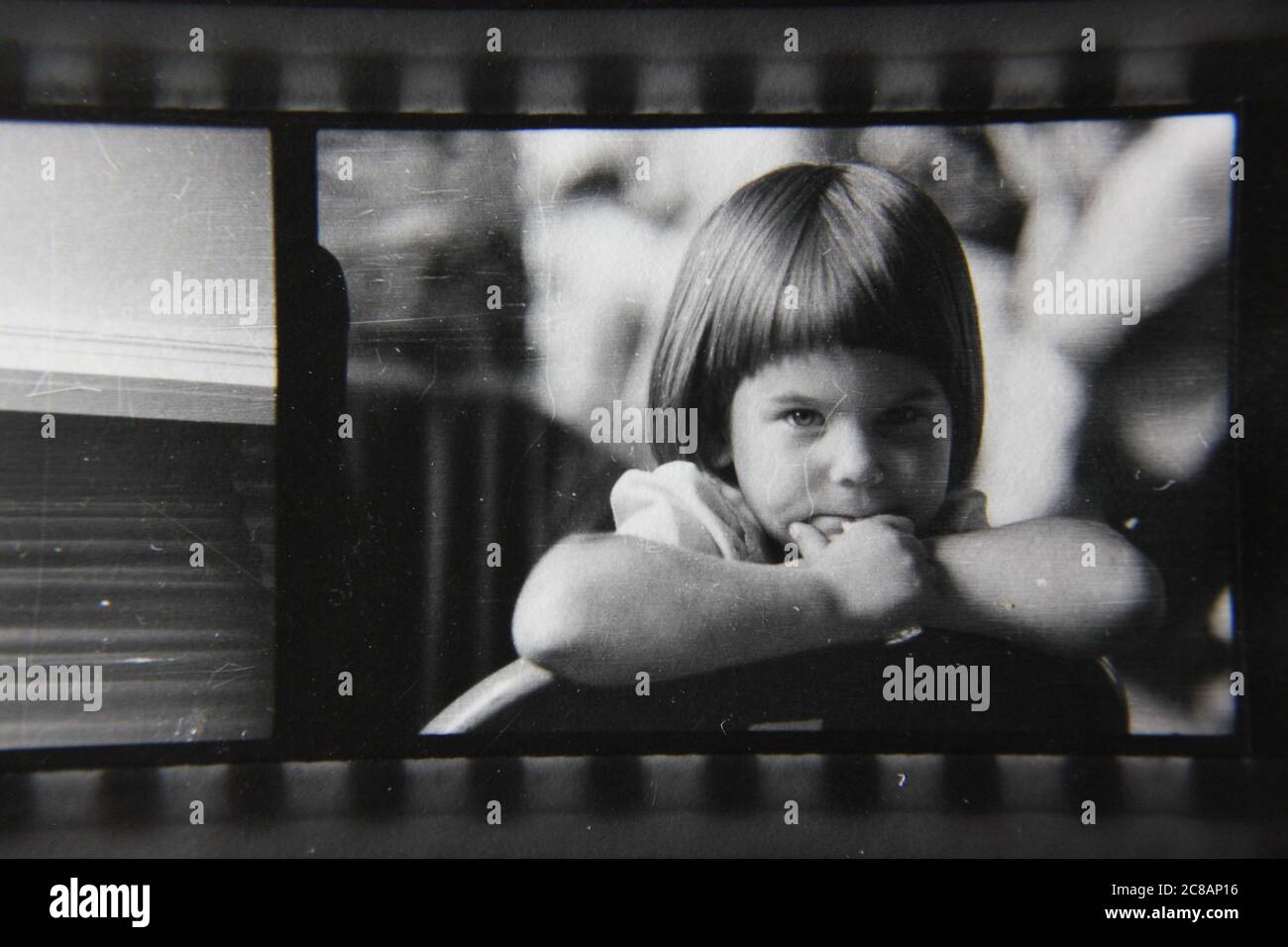 Fine 70s vintage contact print black and white photography of a young girl sporting a pageboy haircut. Stock Photo