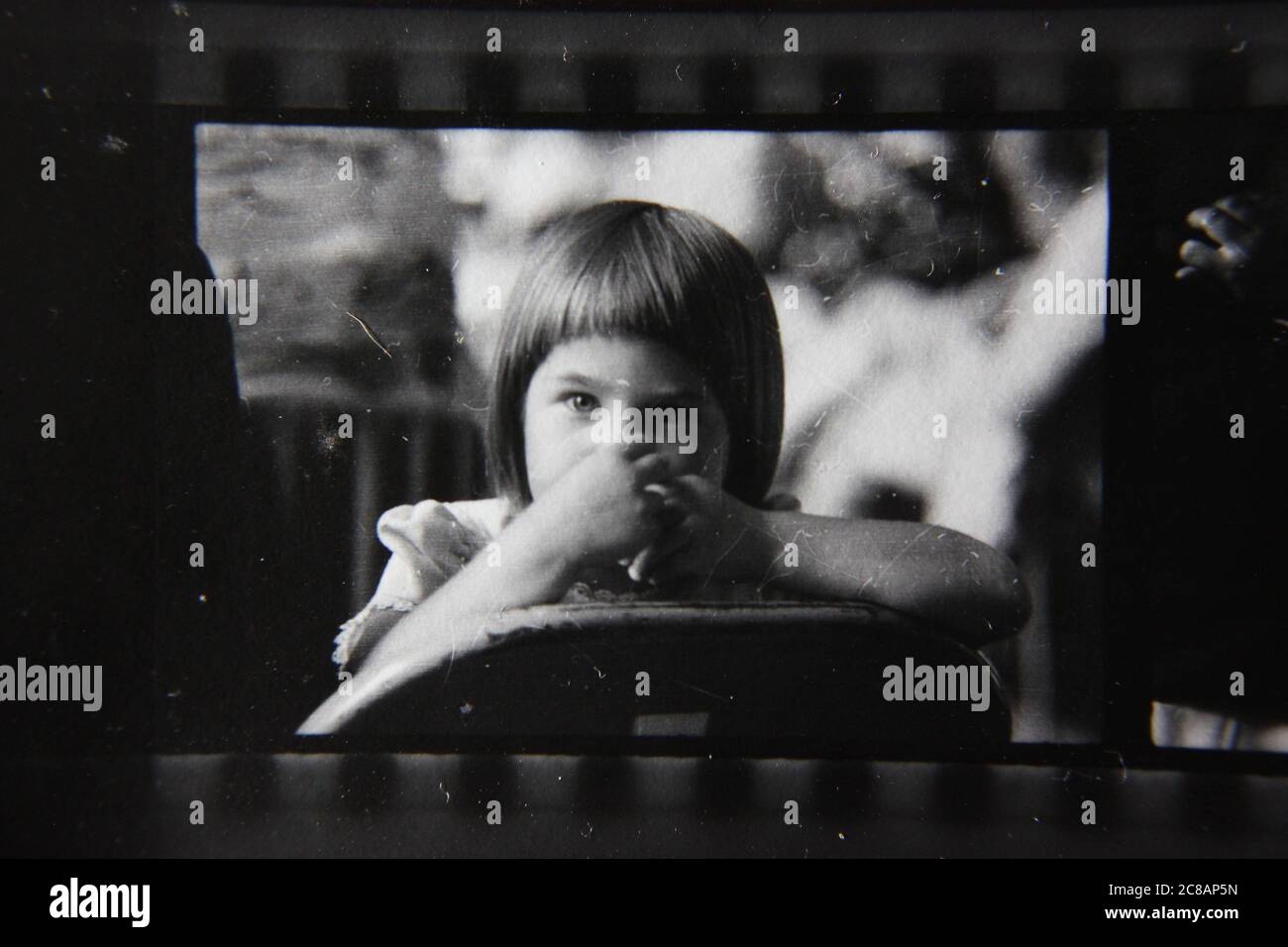 Fine 70s vintage contact print black and white photography of a young girl sporting a pageboy haircut. Stock Photo