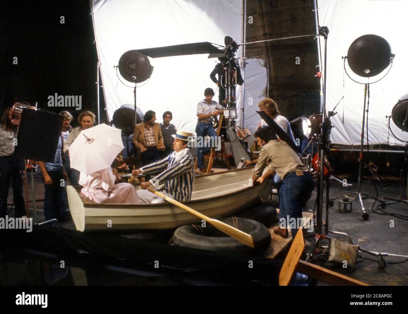 Commercial film production inside studio in Hollywood filming a scene to look like a couple rowing a boat  on a lake. Stock Photo