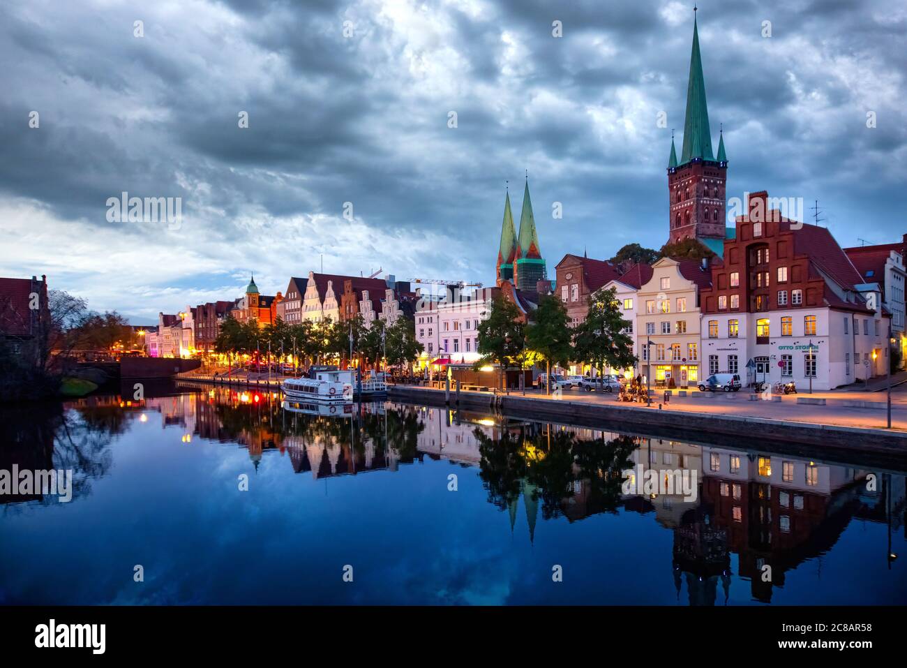 Lübeck, Germany, 10/07/2019: Historic buildings reflected in Trave river, old town of Lubeck, Schleswig-Holstein, northern Germany Stock Photo