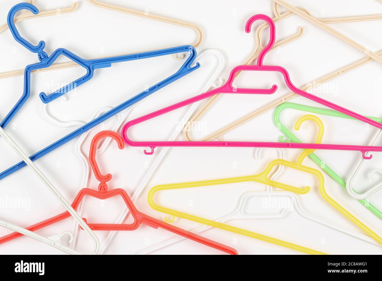 collection of colorful plastic hangers on white Stock Photo